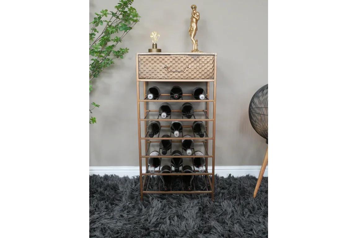 Gold metal wine rack with drawer, holding wine bottles, on grey shaggy rug in modern room