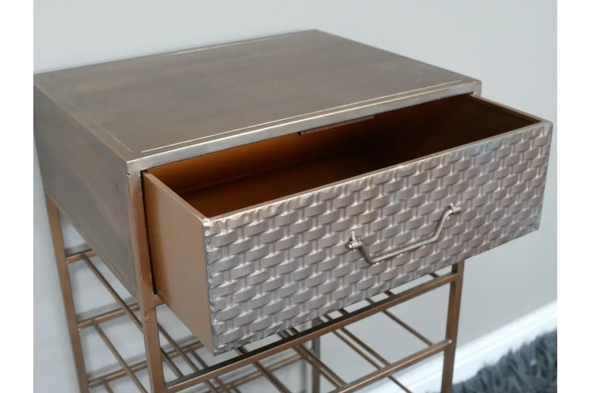 Metal bedside table with open drawer and textured front panel