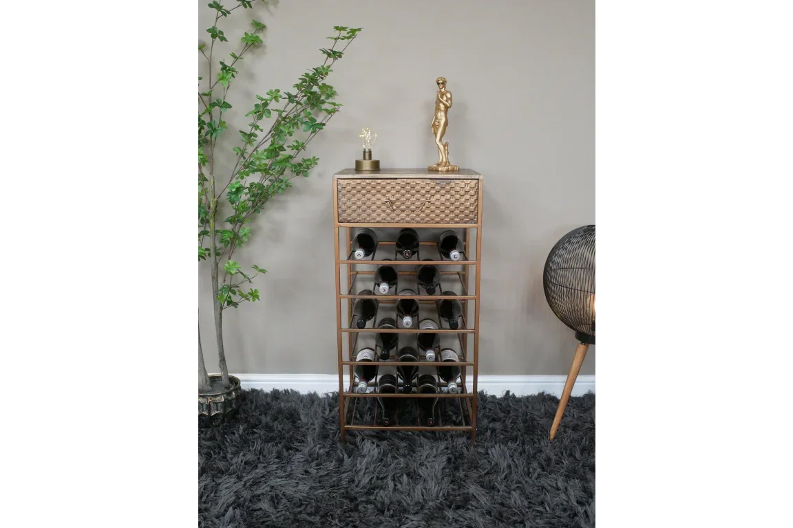 Gold metal wine rack with drawer and decor accents on top in living room setting