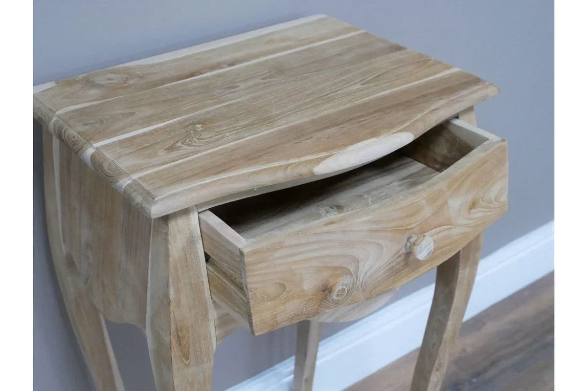 Natural wood bedside table with single drawer partially open, curved legs