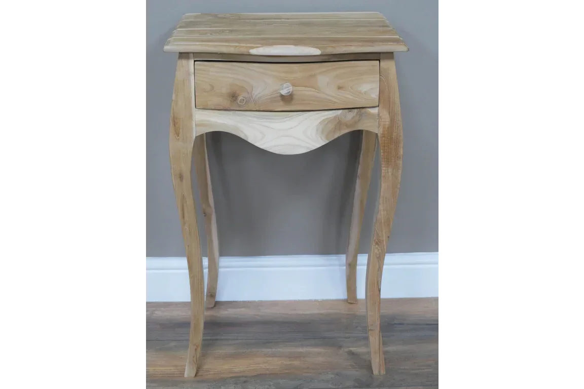 Natural wood bedside table with single drawer and curved legs on wooden flooring