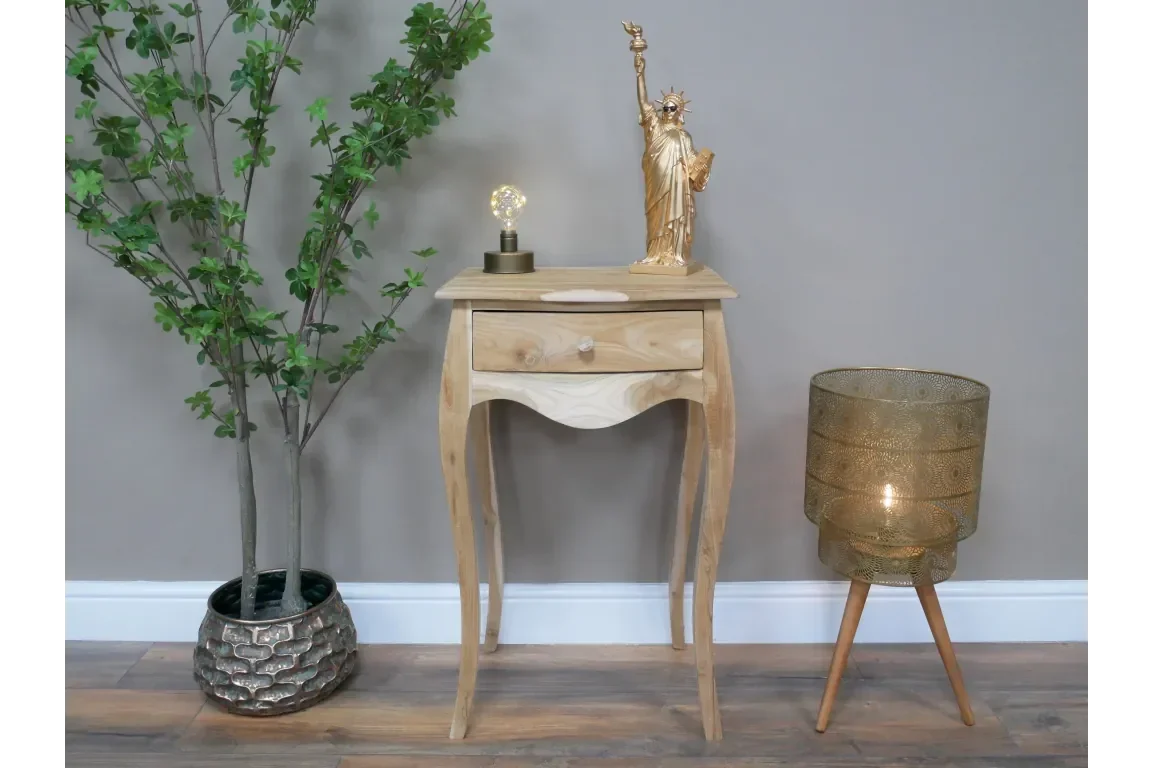 Natural wood side table with drawer, styled with gold lamp, decor and potted plant