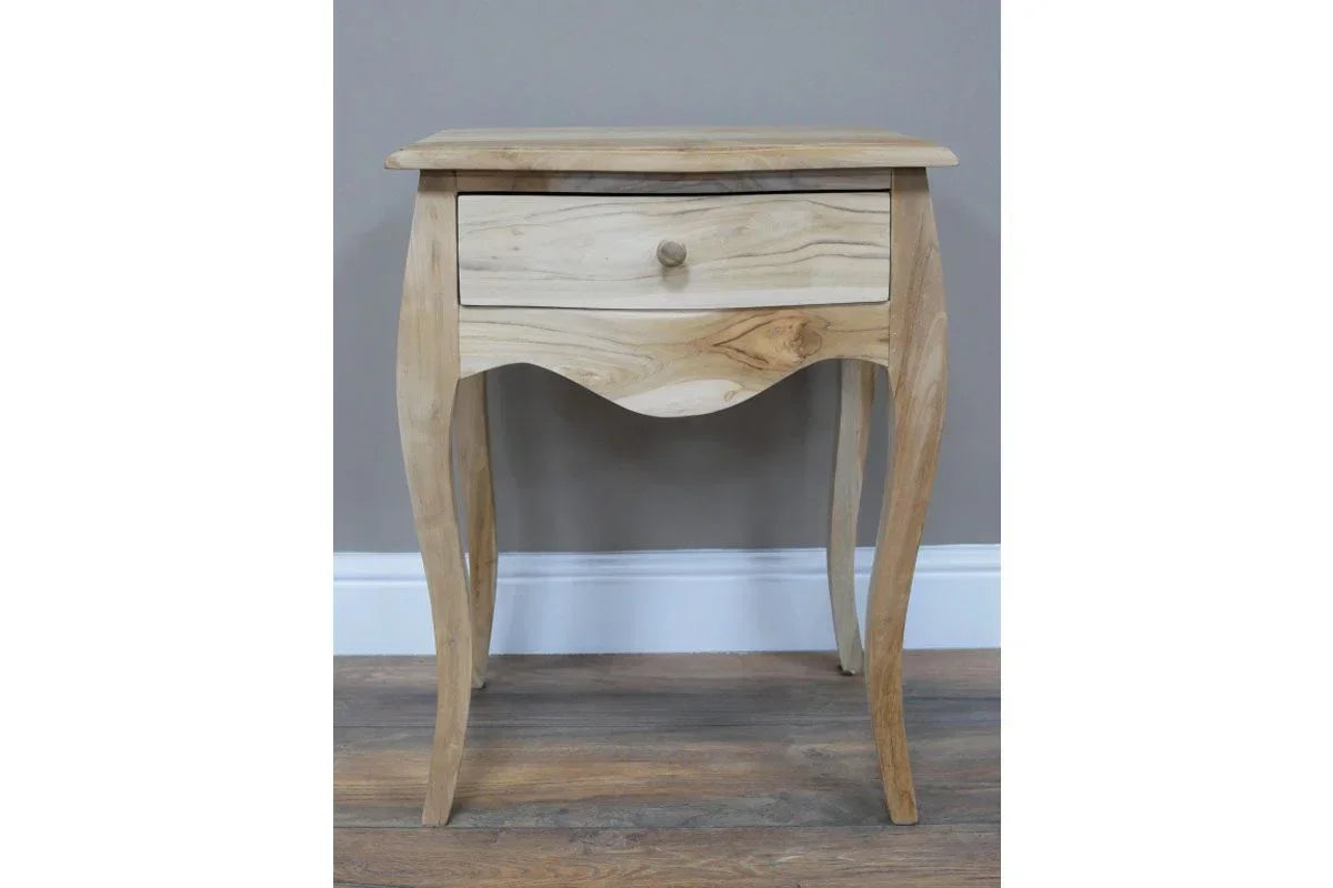 Natural wood bedside table with single drawer and curved legs on wooden floor