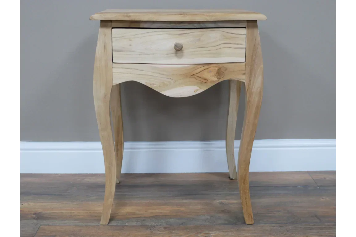 Solid wood bedside table with single drawer and curved legs on wooden floor