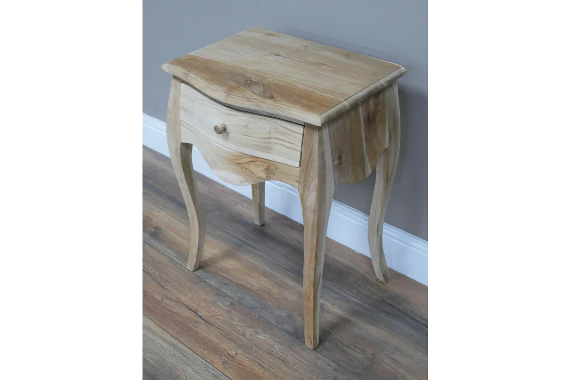 Solid wood bedside table with curved legs and single drawer on laminate floor