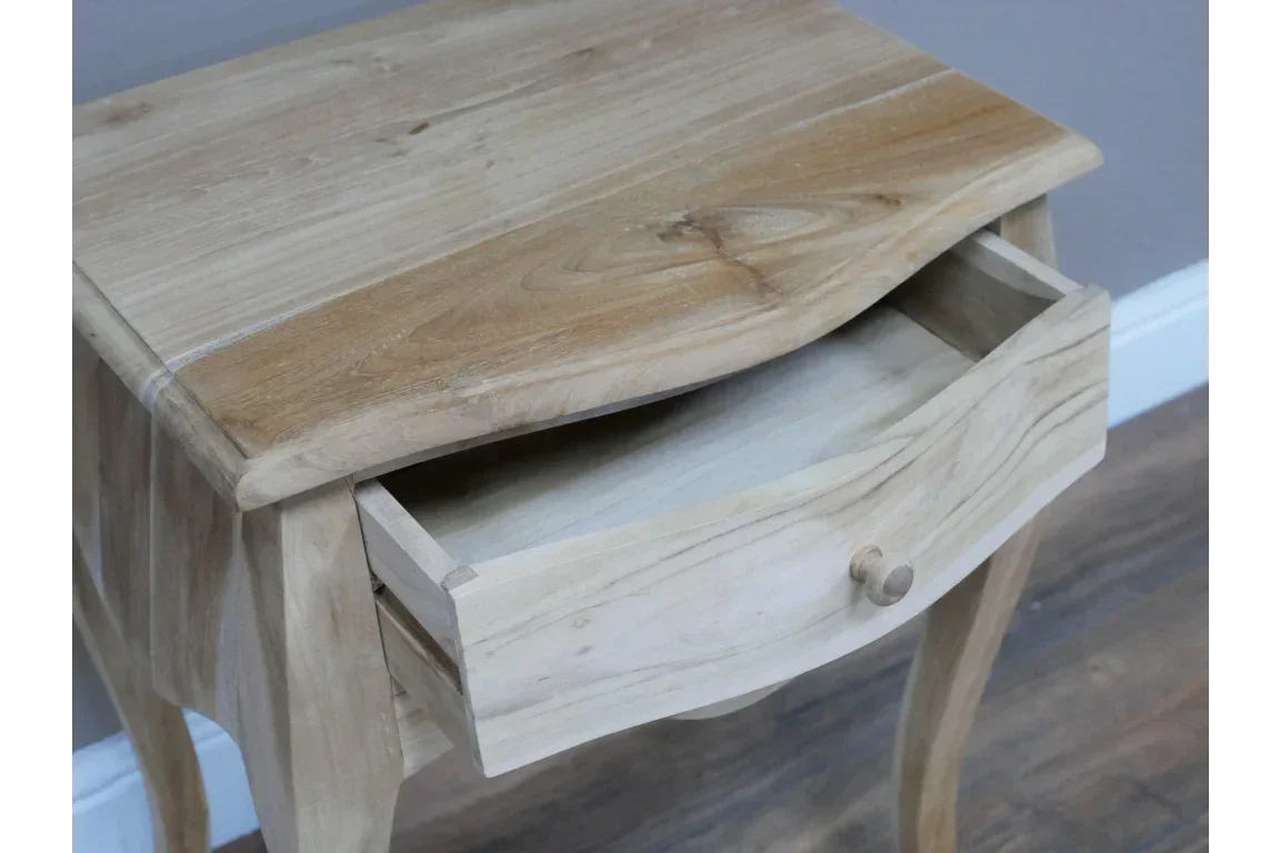 Natural wood bedside table with curved legs and open drawer on wooden floor
