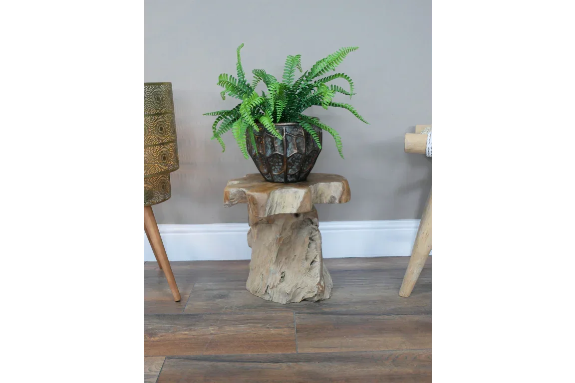 Rustic wooden side table with natural finish, topped with plant in decorative pot on wood floor