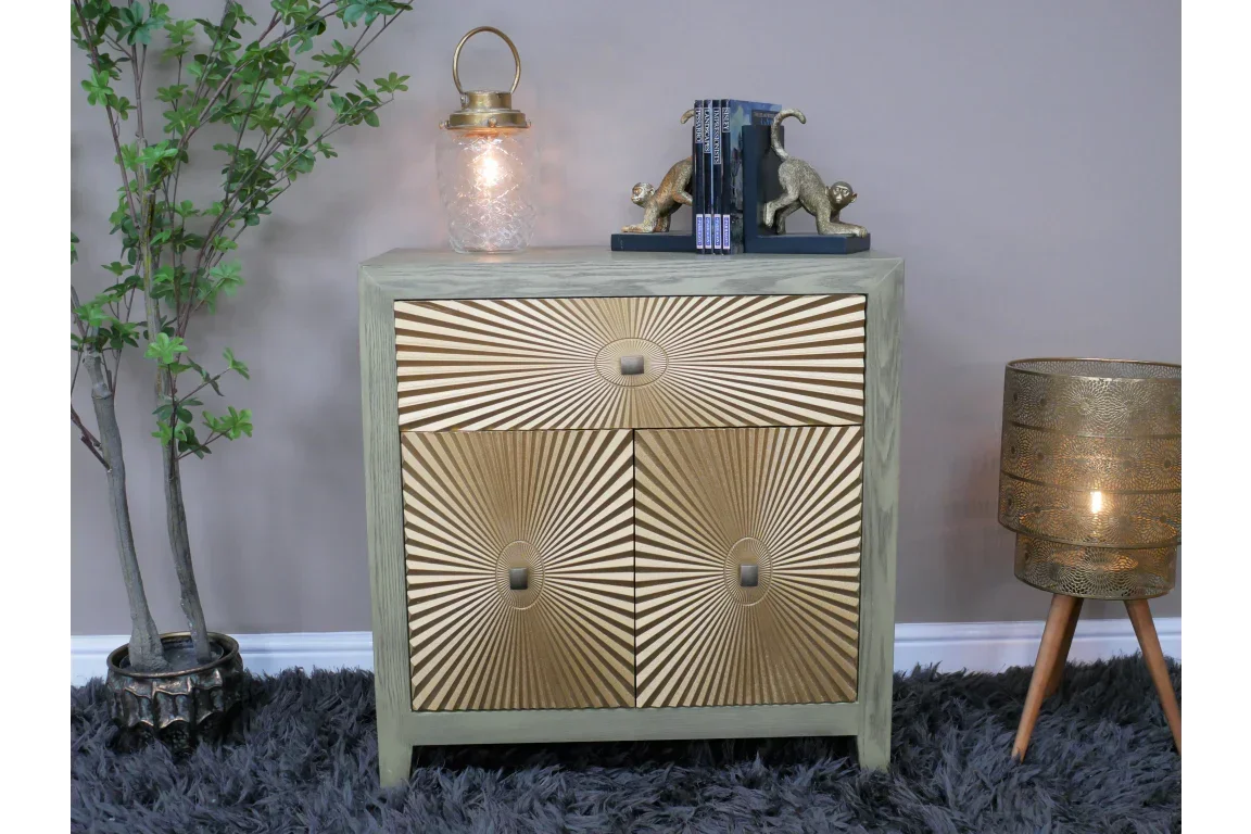 Gold sunburst pattern sideboard with three drawers in modern living room setting