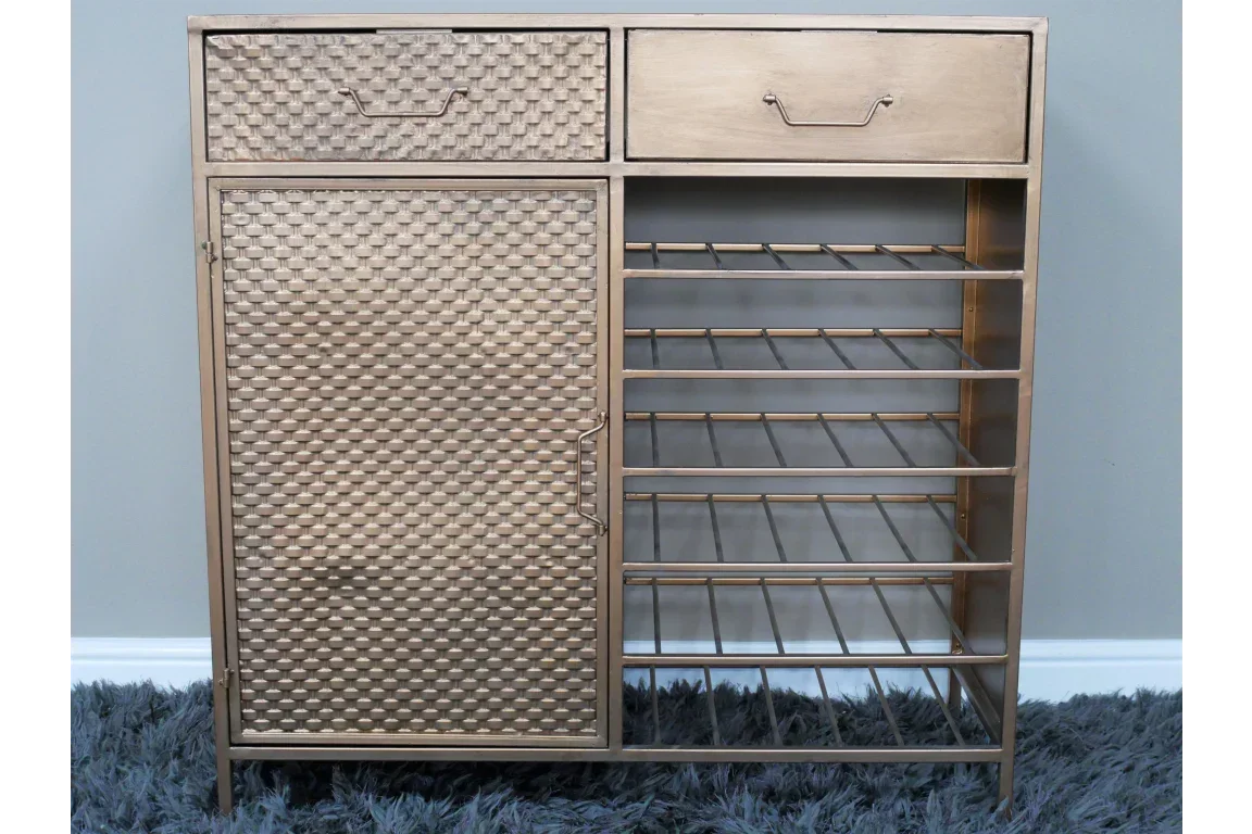 Gold metal storage cabinet with embossed door, two drawers, and open shelving on grey rug