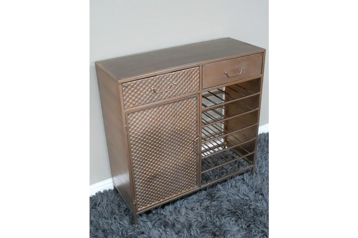 Gold metal wine cabinet with patterned door, two drawers, and open bottle storage shelves