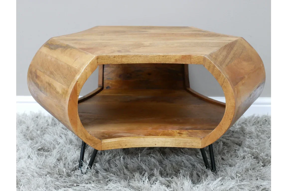 Solid wood coffee table with open storage and black metal legs on grey rug