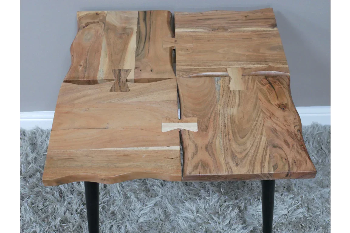 live edge wooden side table with butterfly joints on light grey rug