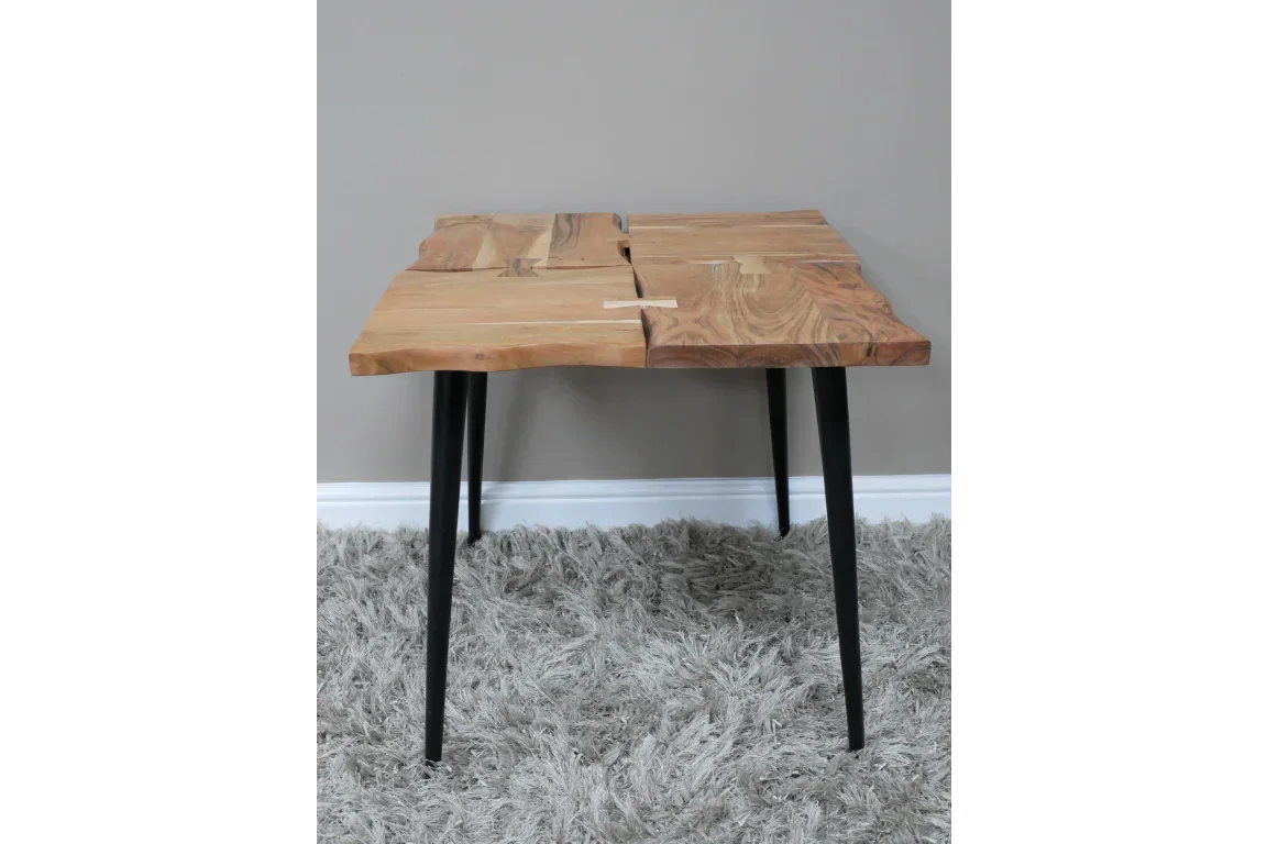 Live edge wooden coffee table with black metal legs on grey rug