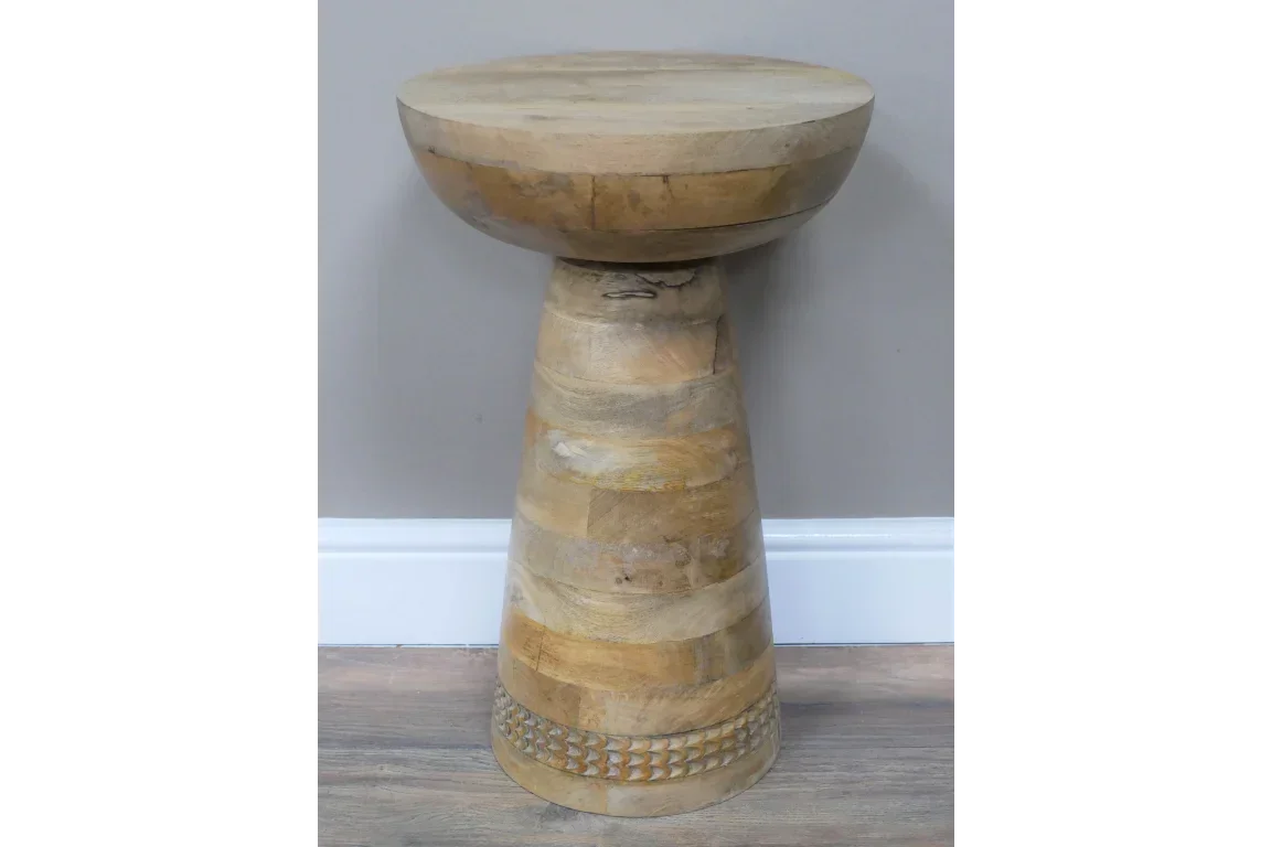 Round mango wood side table with tapered base and carved detail on lower section