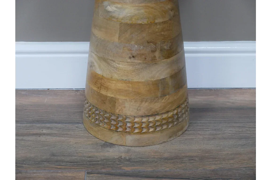 Solid mango wood side table with carved band detail on wooden floor