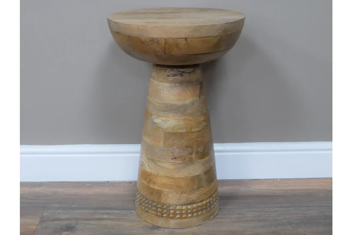Round rustic wooden side table with tapered base and carved detail on the bottom