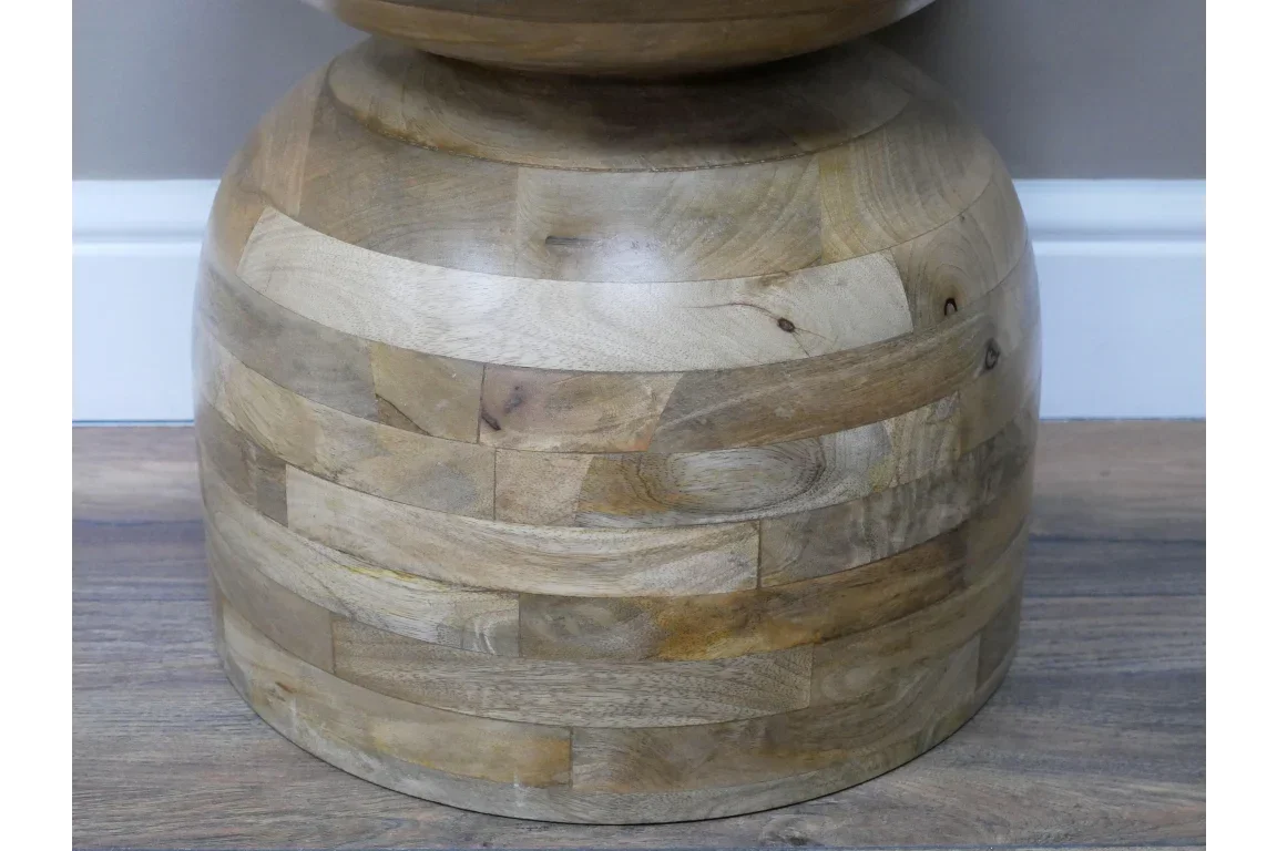 Close view of round wooden side table base with natural grain and block pattern