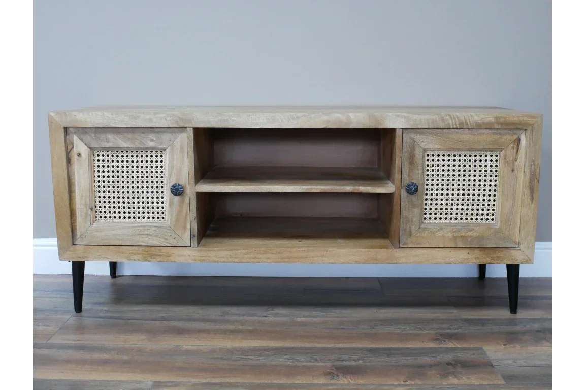 Mango wood TV unit with rattan panel doors, black legs, and open center shelves