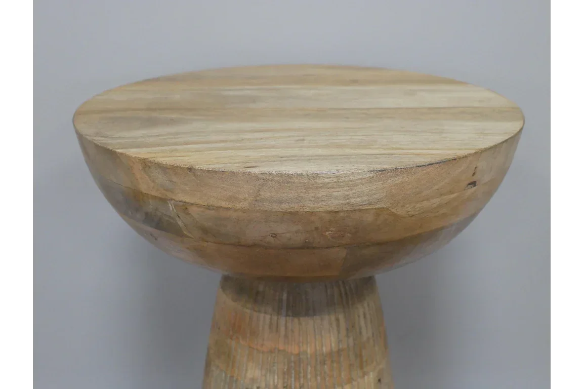 Round solid wood side table with natural finish, close-up of tabletop and base detail