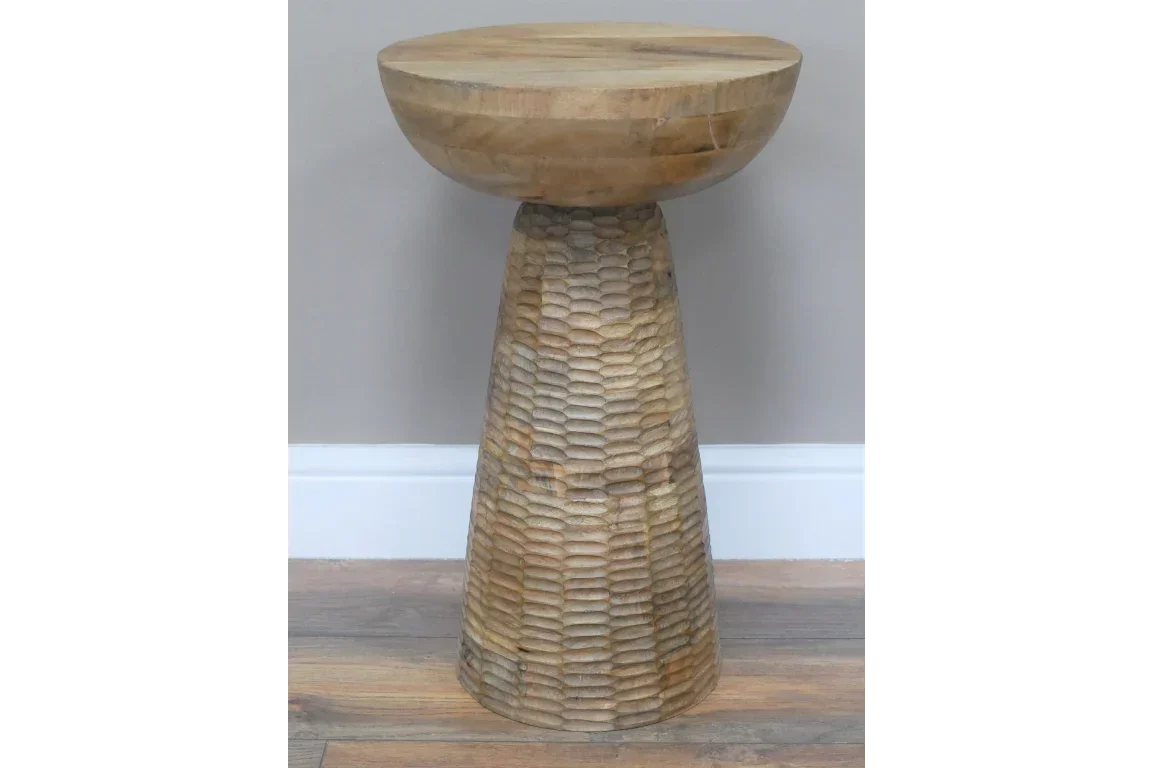 Handcrafted wooden side table with textured conical base and round top on oak flooring