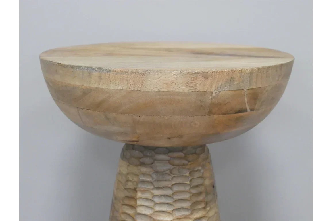 Round wooden side table with smooth top and textured carved pedestal base
