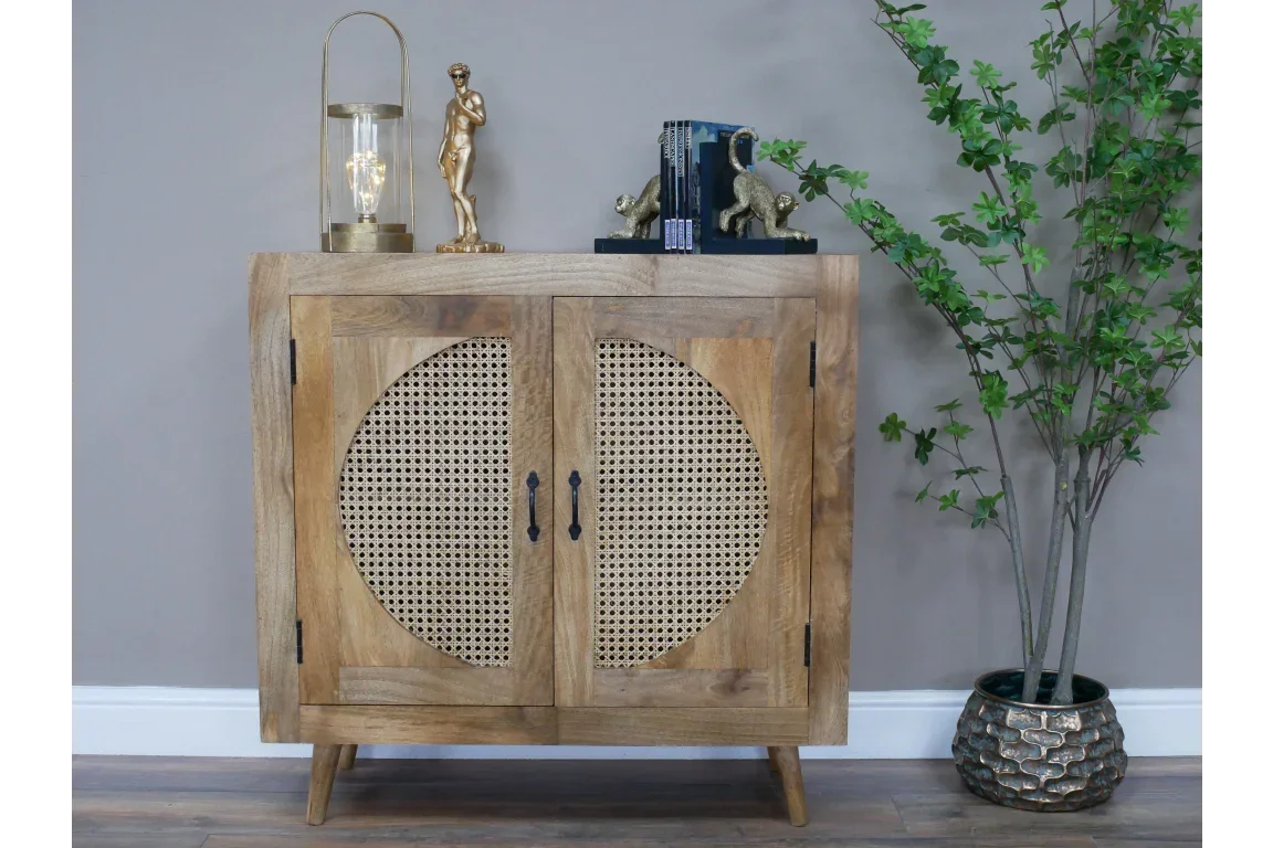 Wooden sideboard with rattan doors, decorative handles, and mid-century legs against grey wall