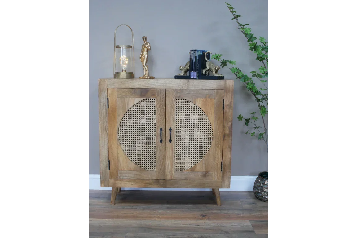 Wooden sideboard cabinet with rattan doors, decorative items on top, modern home setting