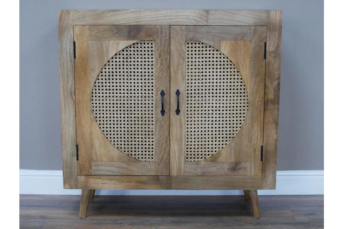 Wooden sideboard cabinet with rattan doors and black handles on wood floor