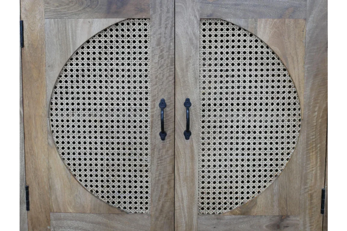 Wood cabinet doors with woven rattan panels and black metal handles, close-up view