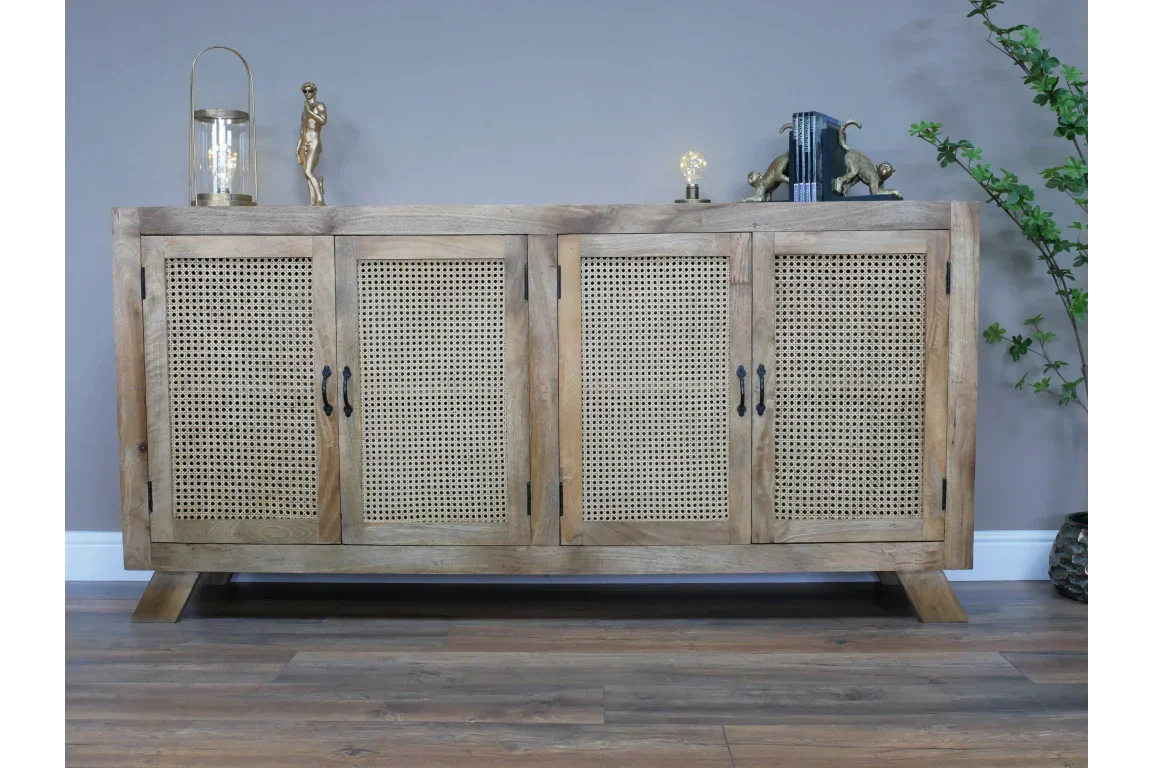 Natural wood sideboard with cane doors and black handles on wooden floor