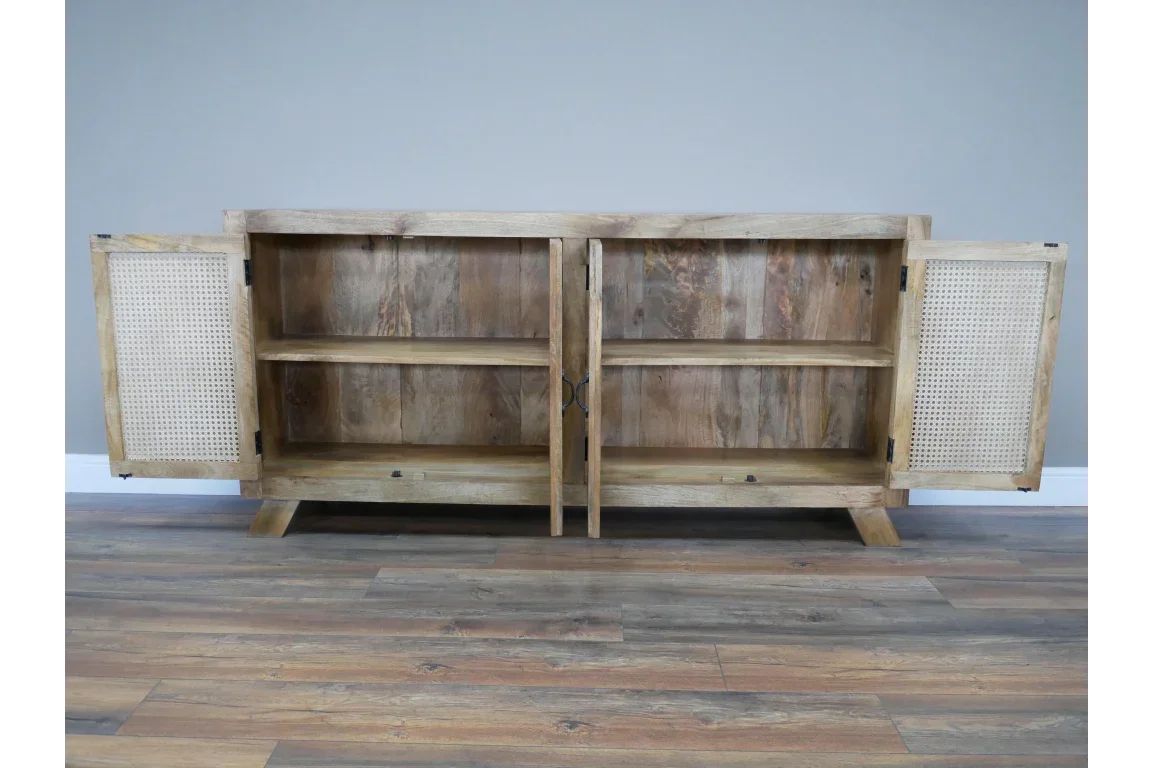 Oak sideboard cabinet with open cane doors and two interior wooden shelves on wood flooring
