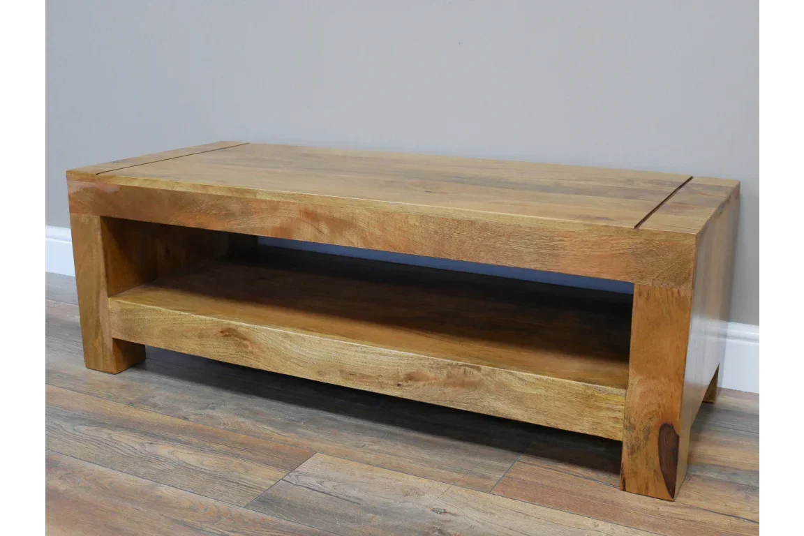 Solid wood coffee table with lower shelf on natural wood flooring
