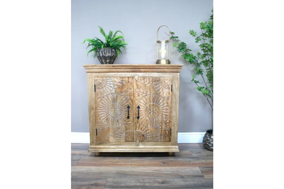 Carved wood sideboard with double doors, decorative handles, and sunburst pattern front