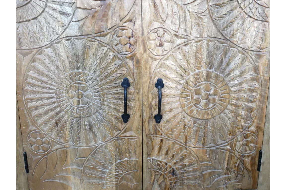 Carved wooden cabinet doors with black metal handles and floral mandala patterns