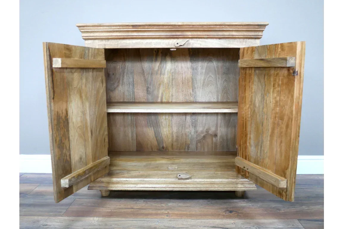 Natural wood storage cabinet with double doors open and internal shelf on hardwood floor