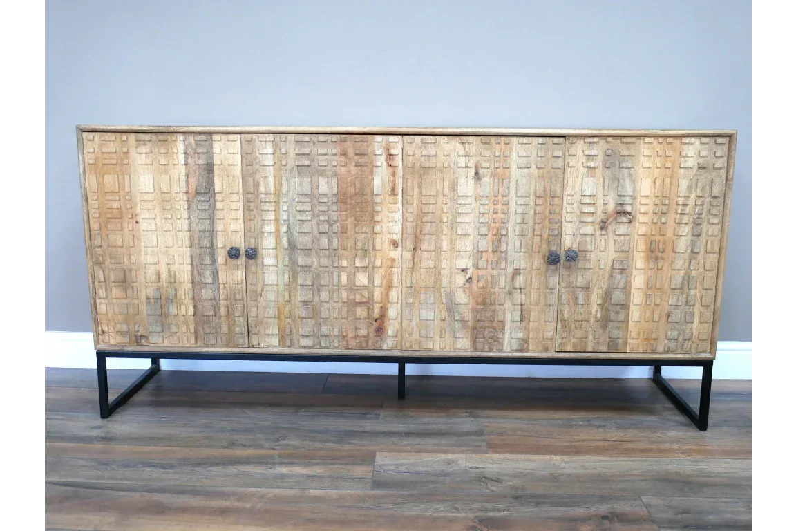 Mango wood sideboard with geometric carved doors and metal legs on wooden floor