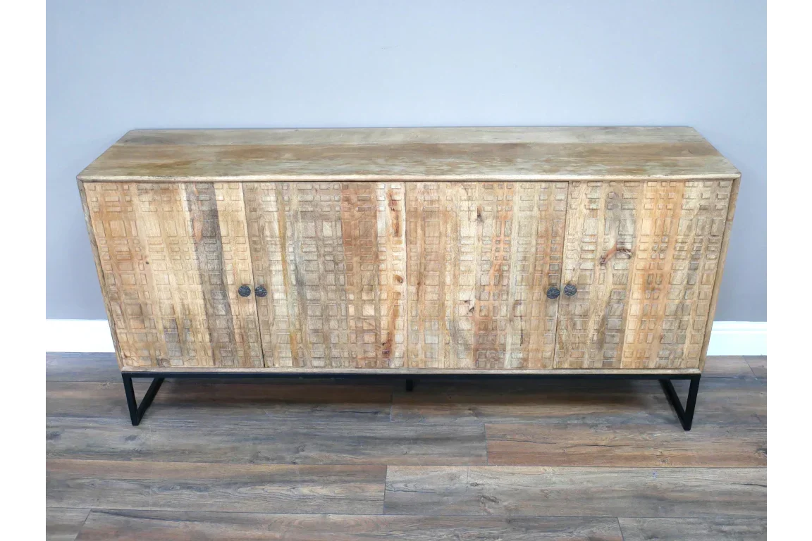 Rustic wood sideboard with textured doors and black metal legs on wood flooring