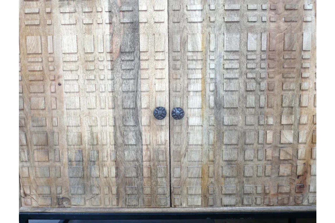 Carved wooden cabinet doors with geometric pattern and round black metal handles