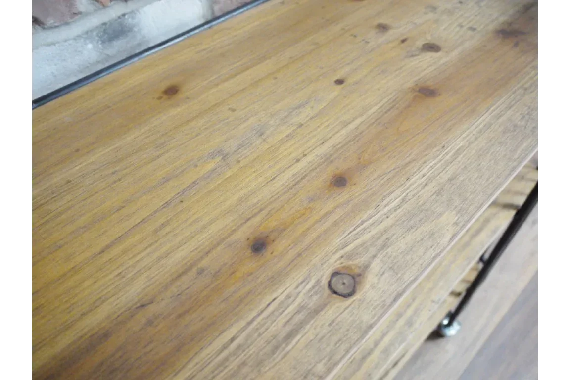 Close detail of wooden furniture surface with natural grain and knots