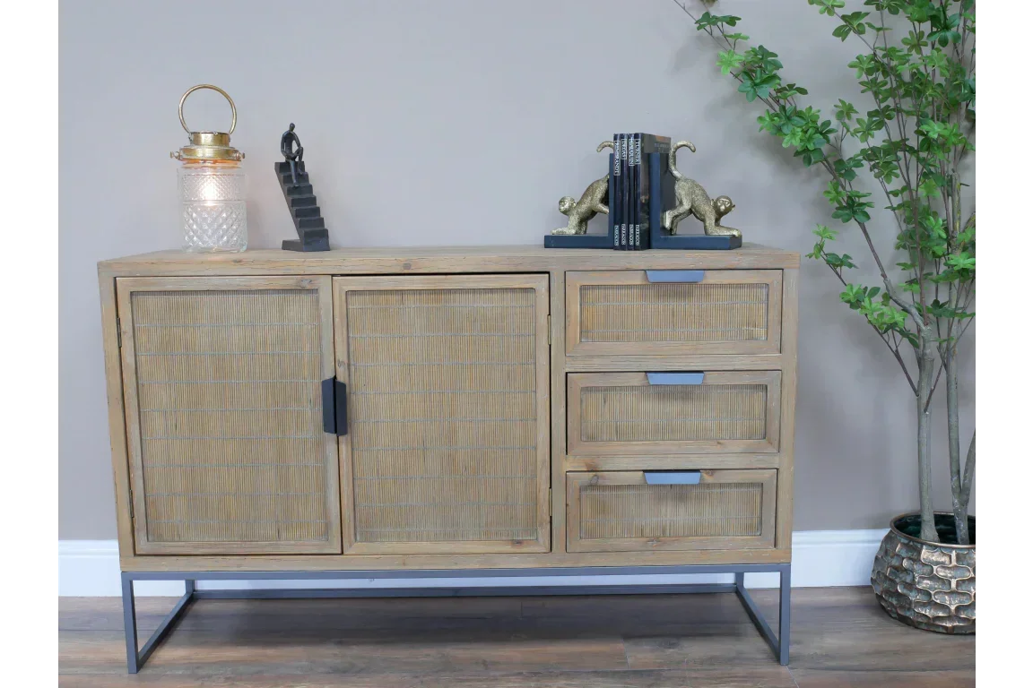 Wooden sideboard with rattan doors, three drawers, and black metal legs in living room