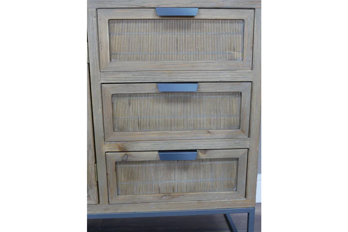 Three drawer wooden chest with rattan panels and metal handles on black base