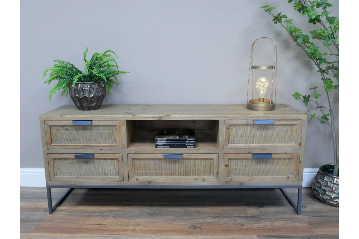 Wooden sideboard with six drawers, open shelf, black metal legs, and decorative plants