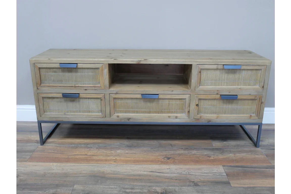 Light wood TV unit with six drawers, open shelf, black handles, and metal legs on wood floor