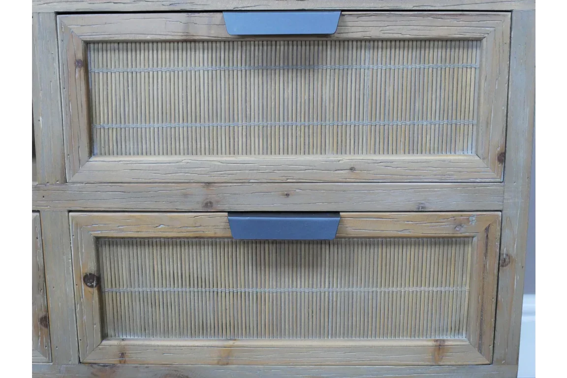 Natural wood chest of drawers with ribbed panel fronts and matte grey handles