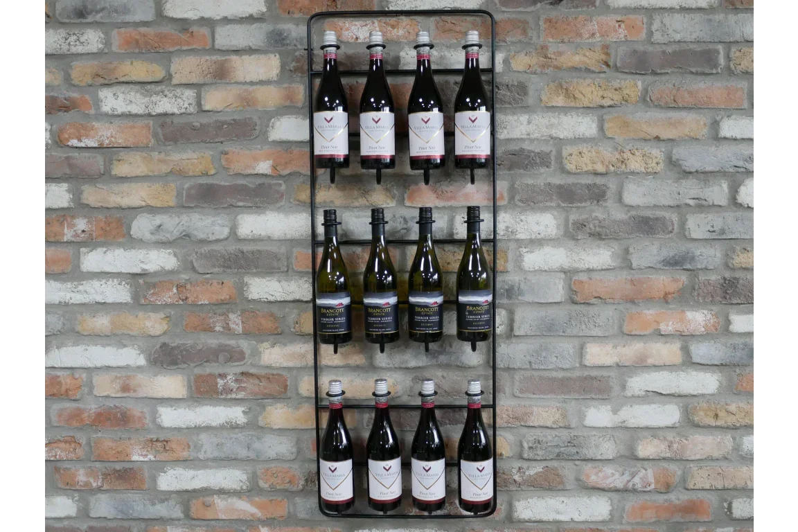 Wall-mounted metal wine rack with assorted wine bottles against exposed brick wall