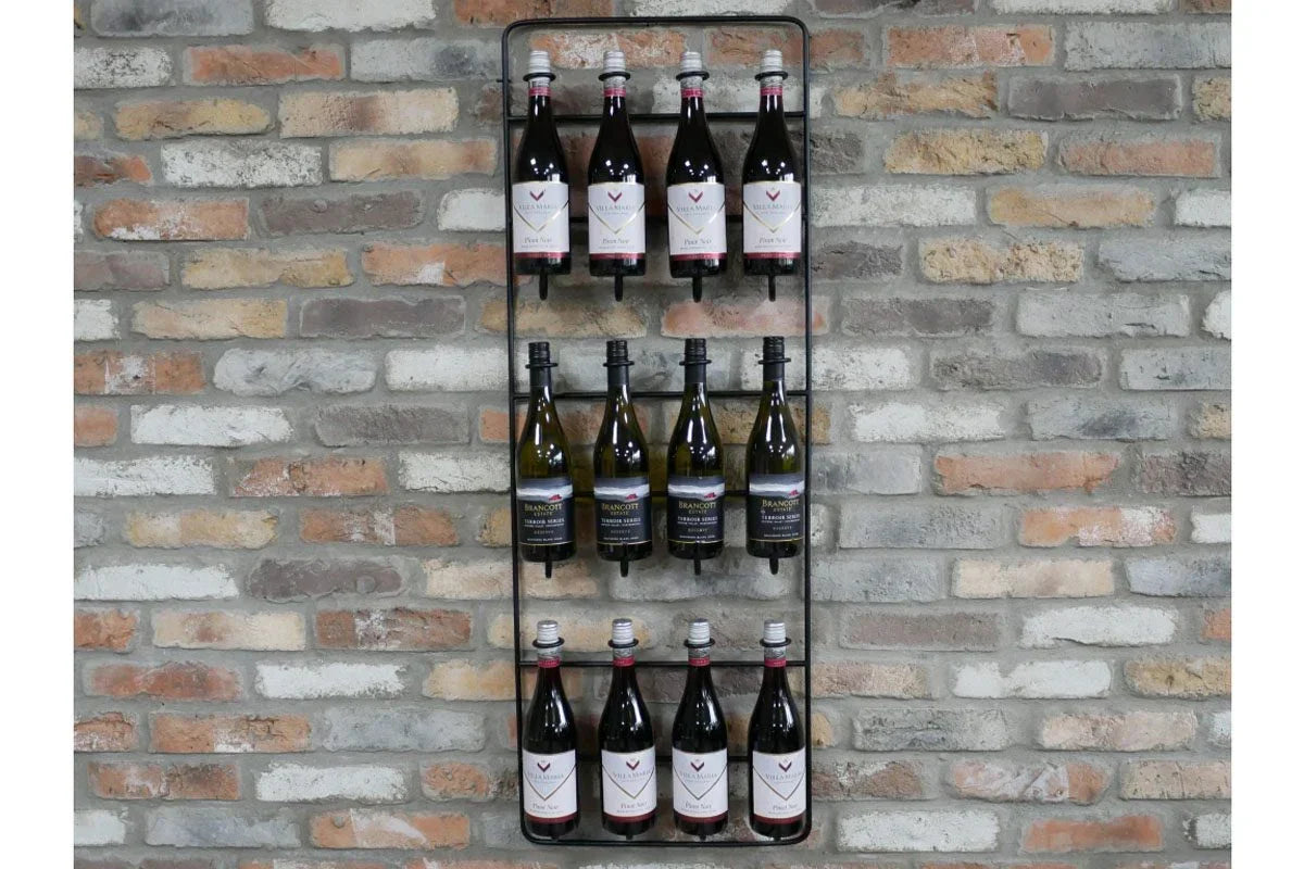 Wall mounted black metal wine rack holding bottles against exposed brick wall