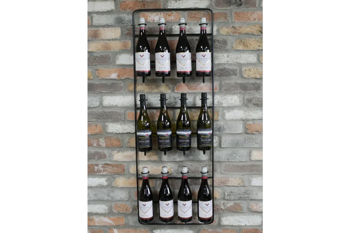 Wall mounted metal wine rack holding twelve wine bottles on exposed brick wall