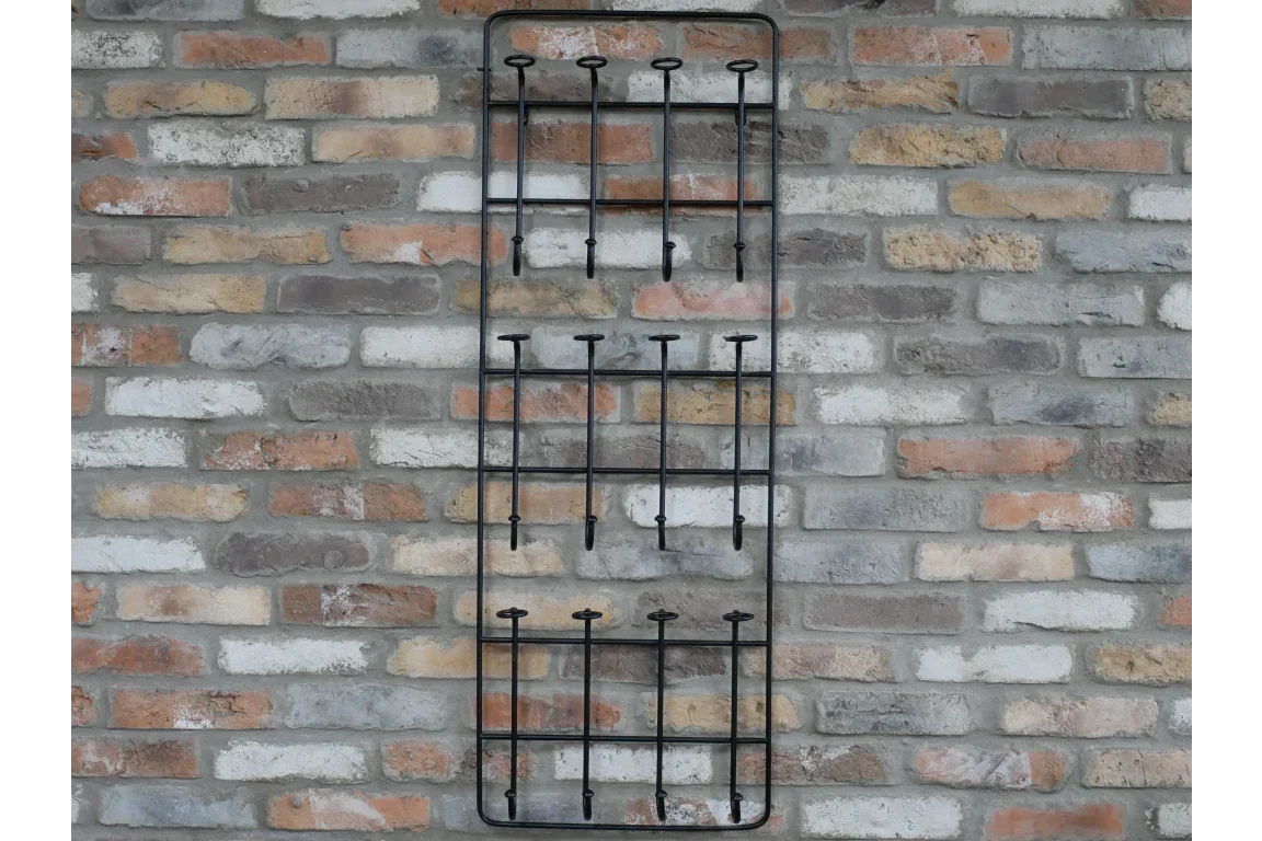 Black metal wine rack mounted vertically on exposed brick wall