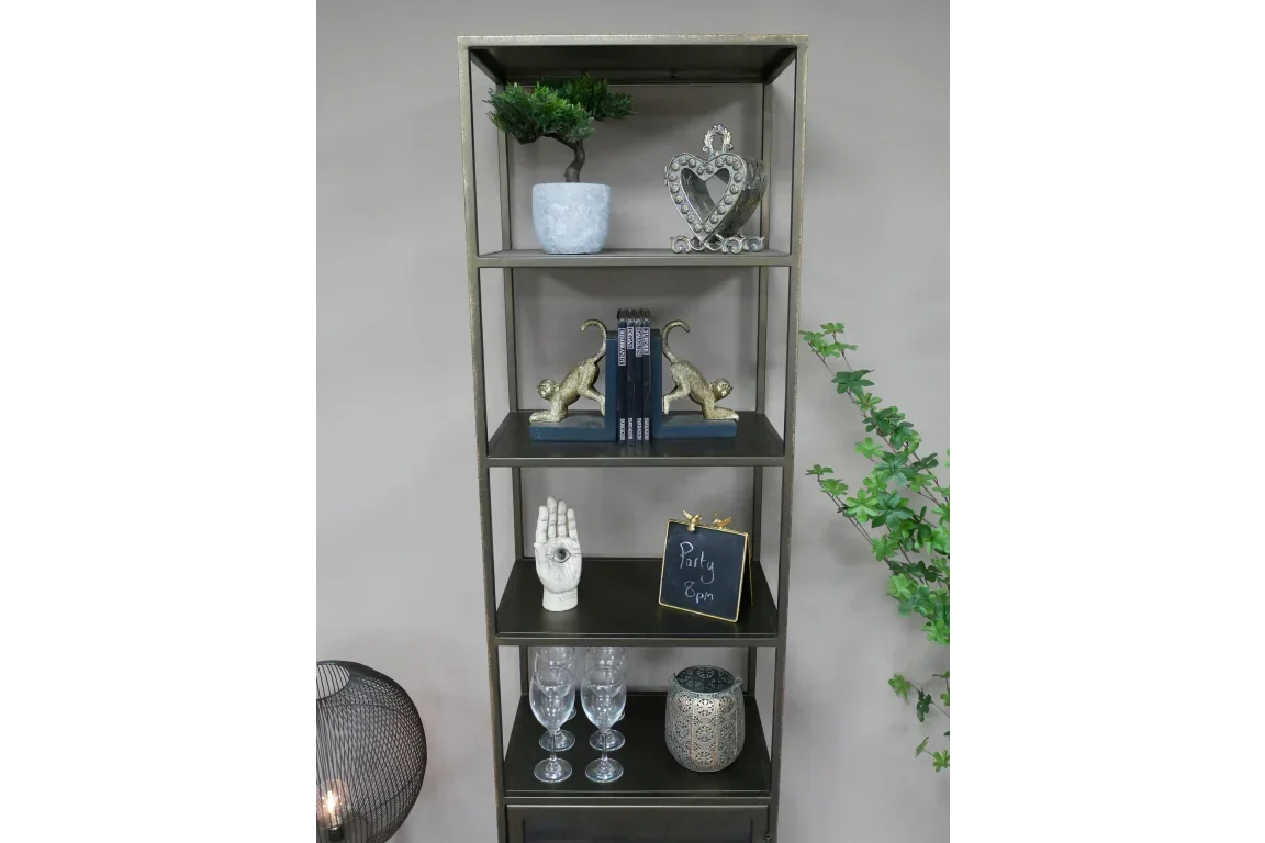 Metal shelving unit with decorative ornaments, books, and glassware against a neutral wall