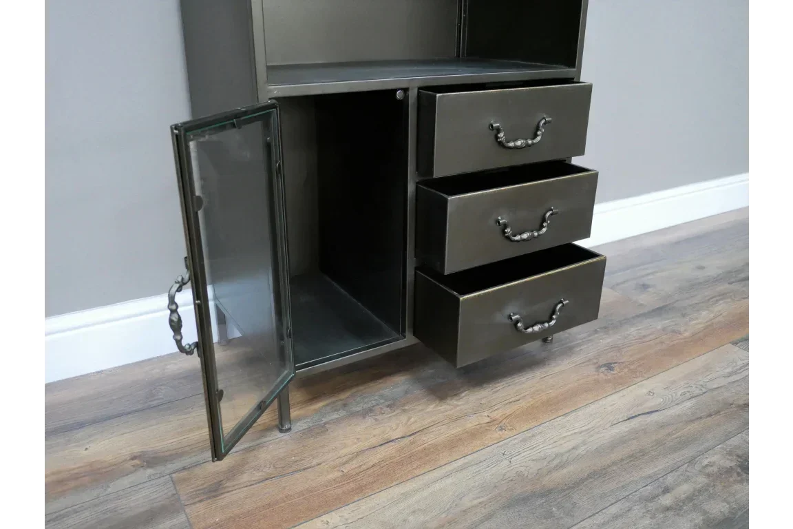 Metal storage cabinet with glass door and three open drawers on wood floor
